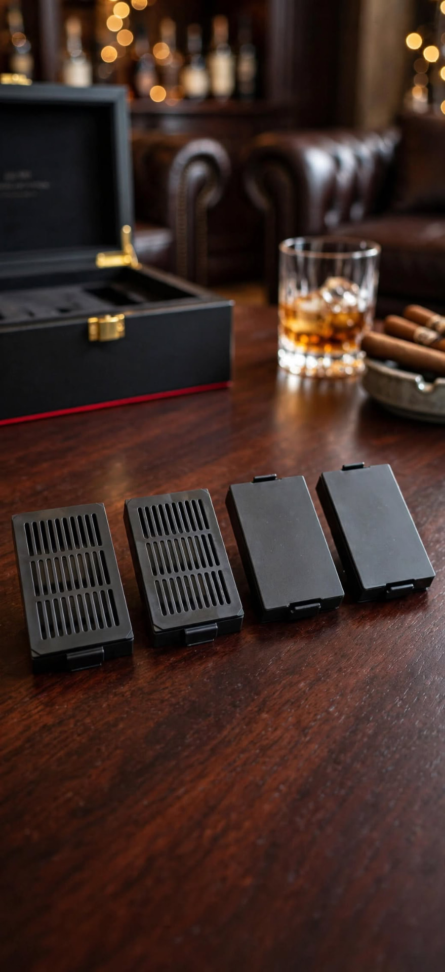 Black HUMI cartridge components arranged on a polished lounge table
